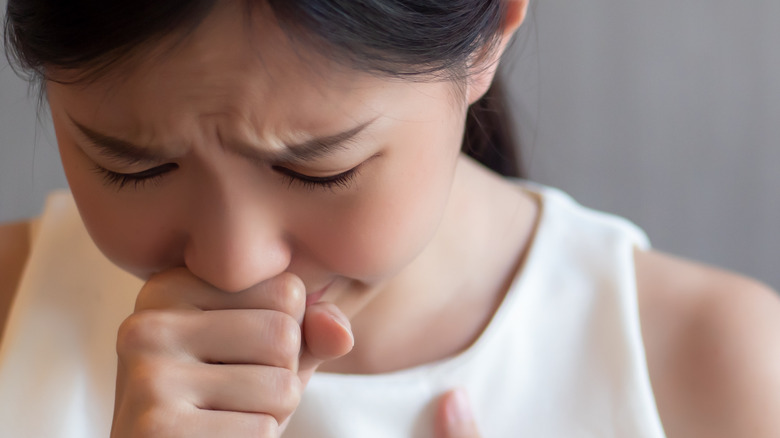 Woman having hiccups