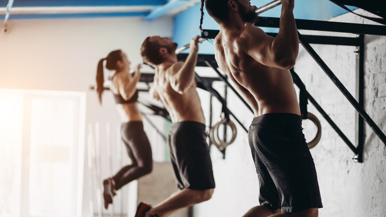 People doing pull-ups at the gym