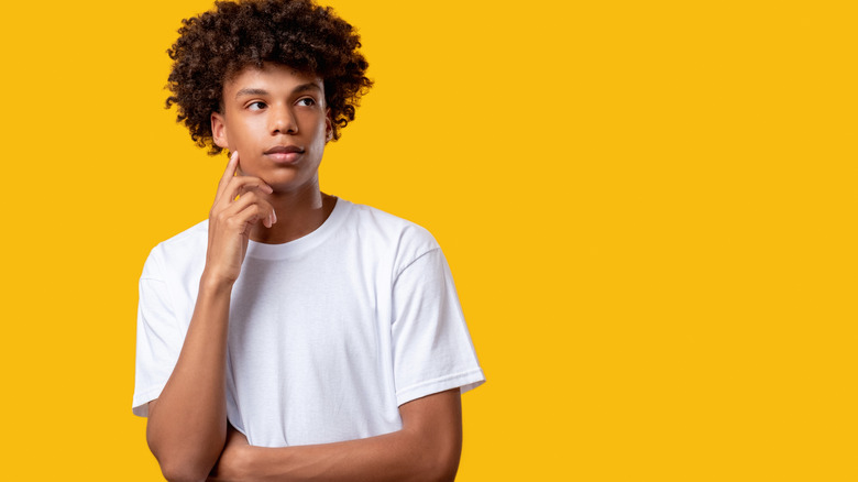 a teenage boy thinking