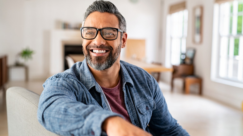 a middle aged bearded man smiling
