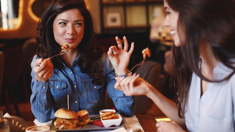 Two women enjoying burgers