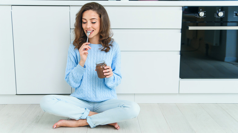 Woman eating peanut butter 