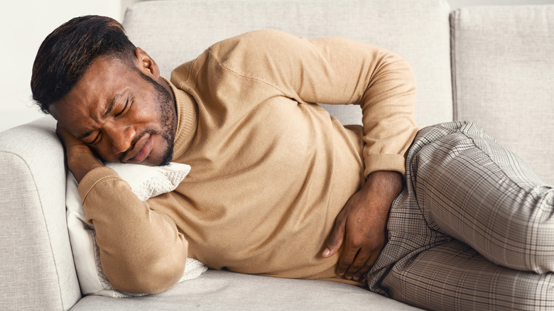 man laying down with stomachache