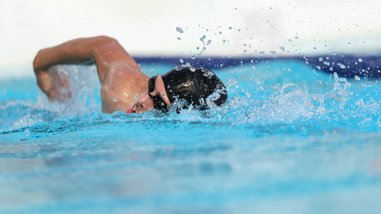 Man swimming laps in pool