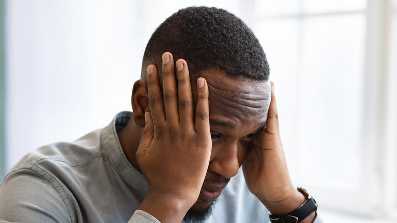 Man with hands on his head