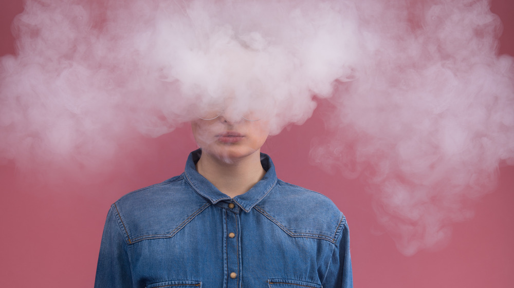 Woman surrounded by smoke 