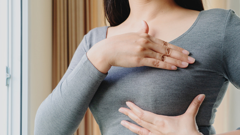 Woman checking her breasts