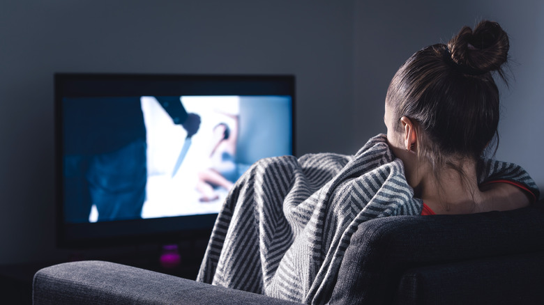 Woman watching horror movie