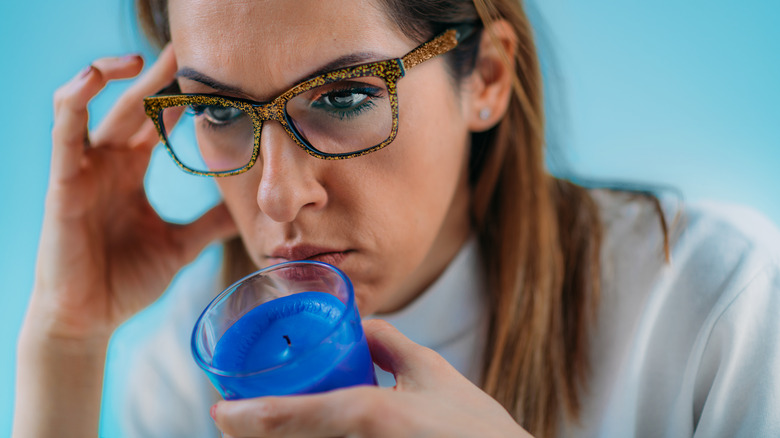 Woman smelling candle