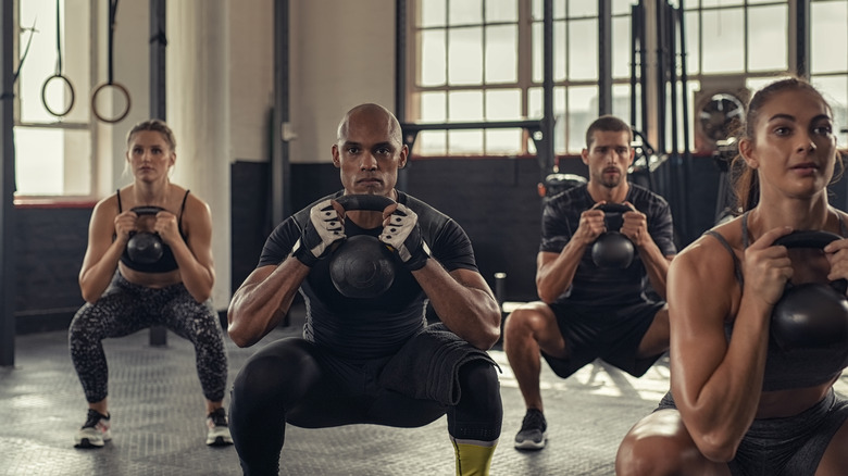 a group fitness class lifting kettlebells