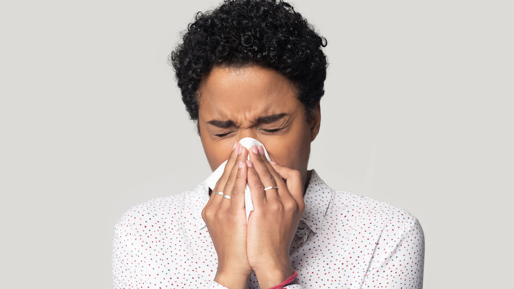 Black woman blowing her nose