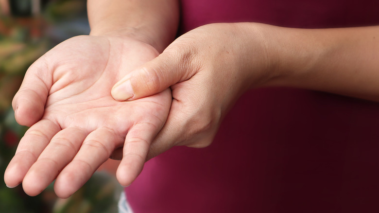 Person touches numb hands