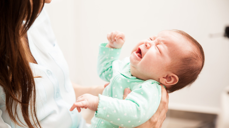 Woman holding crying baby