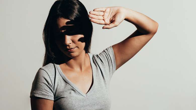 woman protecting eyes from light
