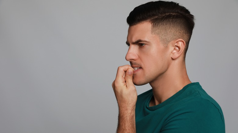 Man biting his nails