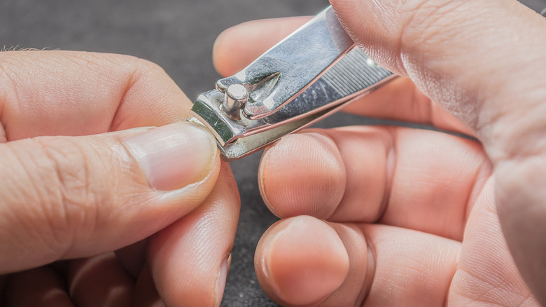 Nail trimmer cutting a thumbnail