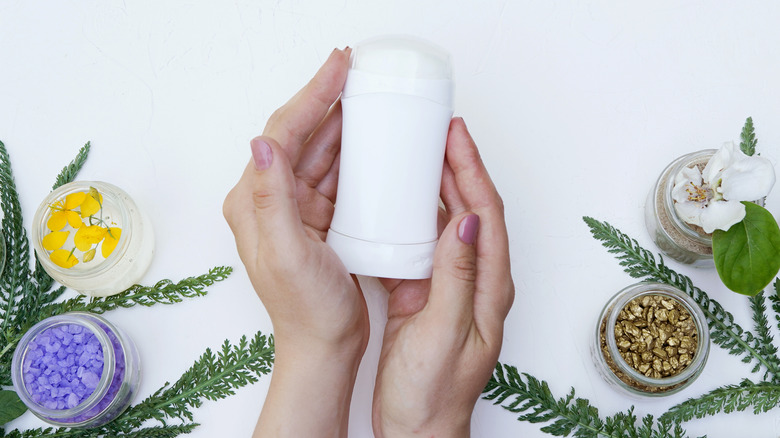 palms holding antiperspirant