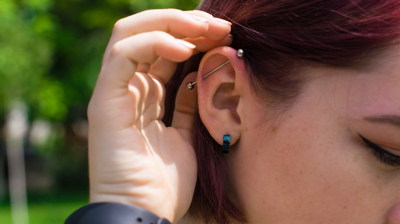 Woman touching her pierced ear