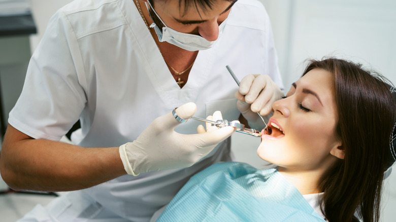 Dentist looking at woman's teeth