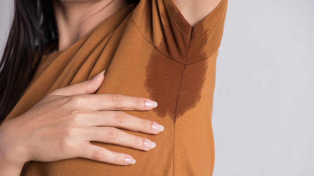 Woman with sweaty underarm 