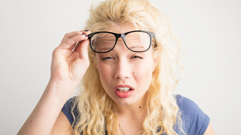 Woman with glasses who's squinting