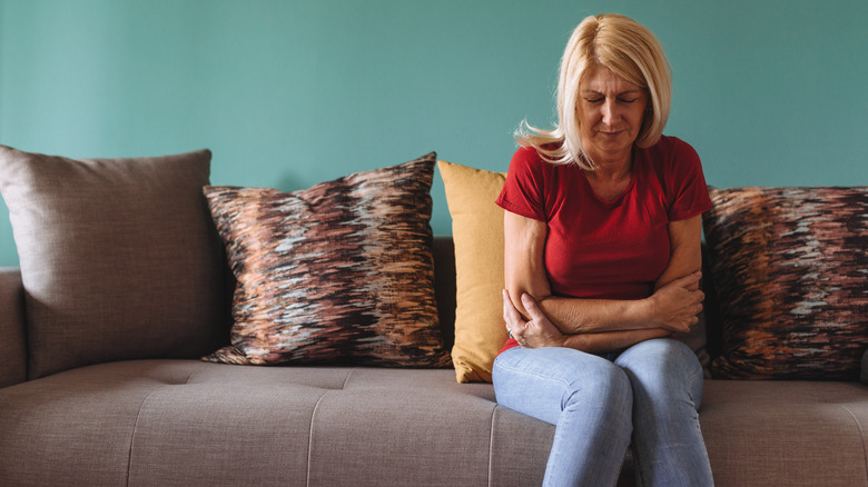 Woman holding stomach