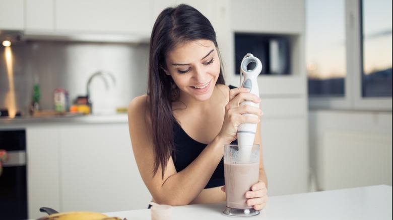 woman mixes protein powder shake