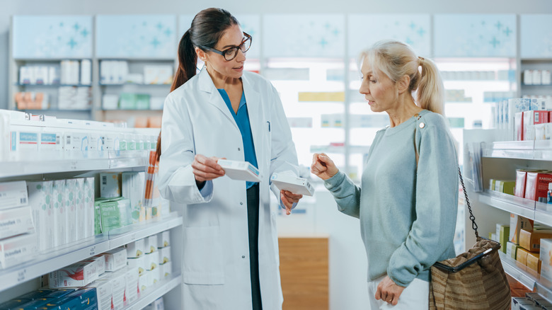 woman deciding between pills