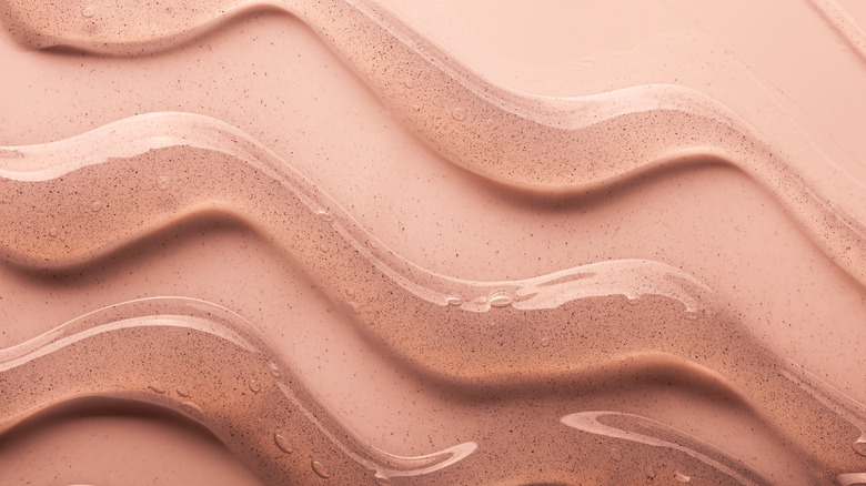 Wavy lines of a gel against a pink background