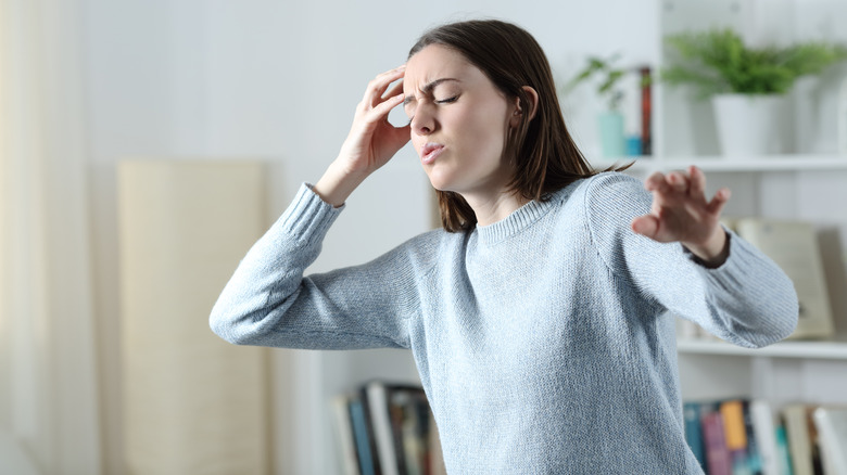 Woman feeling dizzy and about to faint