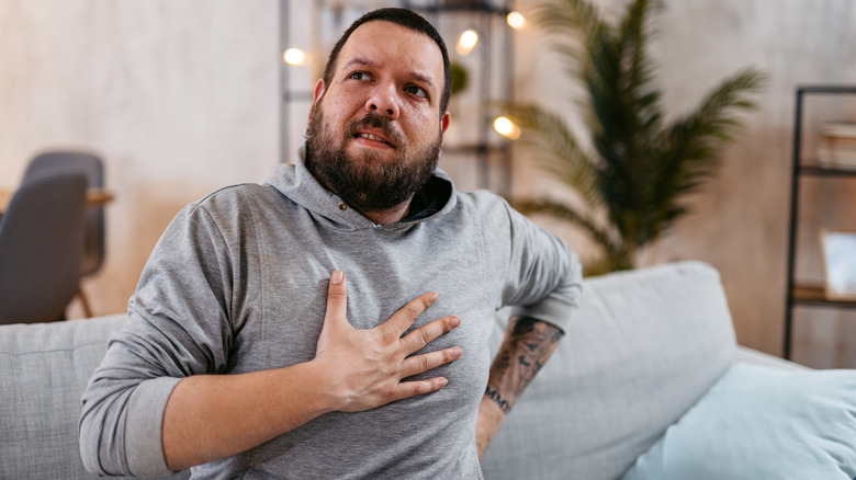 Man with hand on chest