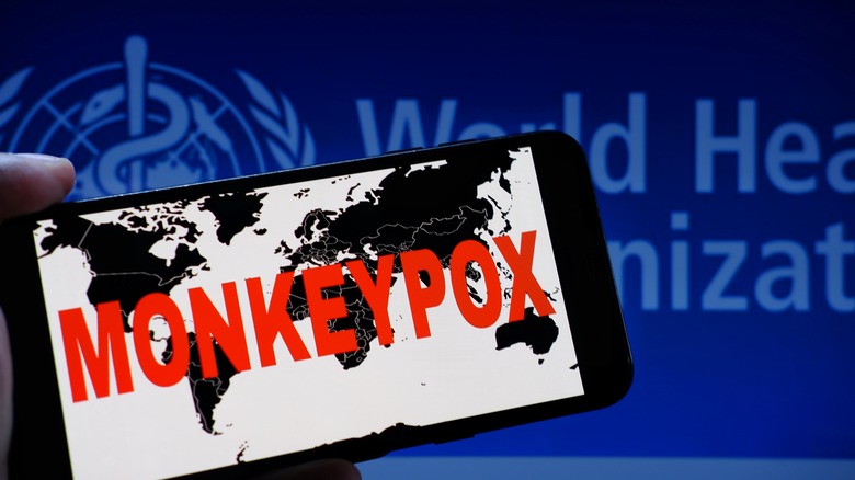 iPhone screen with "Monkeypox" written across a map