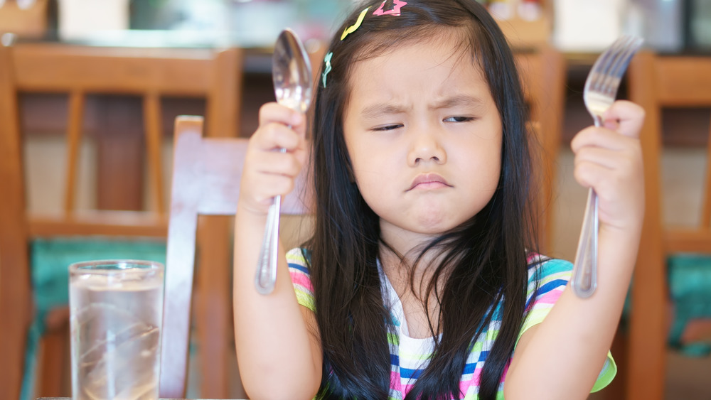 Angry girl with utensils