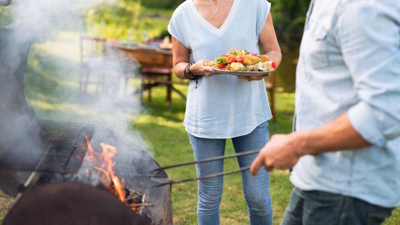 couple grilling meat