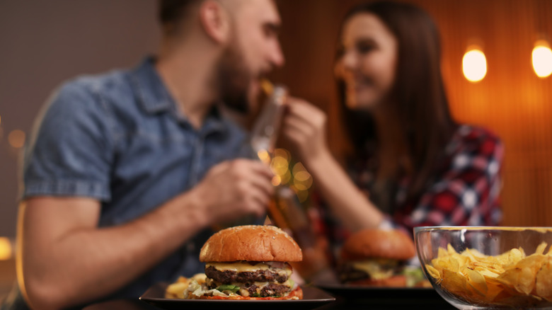 couple eating burgers