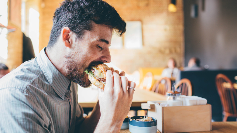 man eating burger