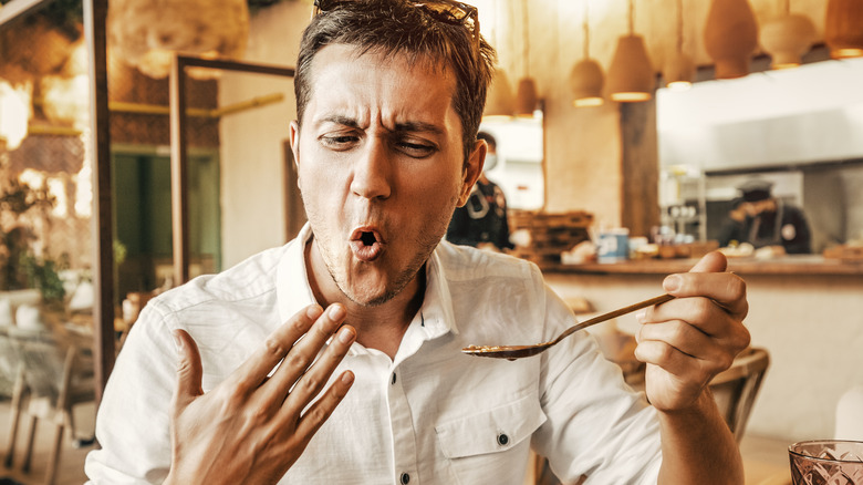 man eating spicy food