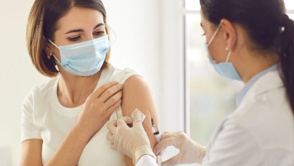 woman receiving vaccine injection in arm