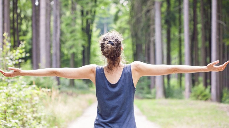 woman outdoors with outstretched arms