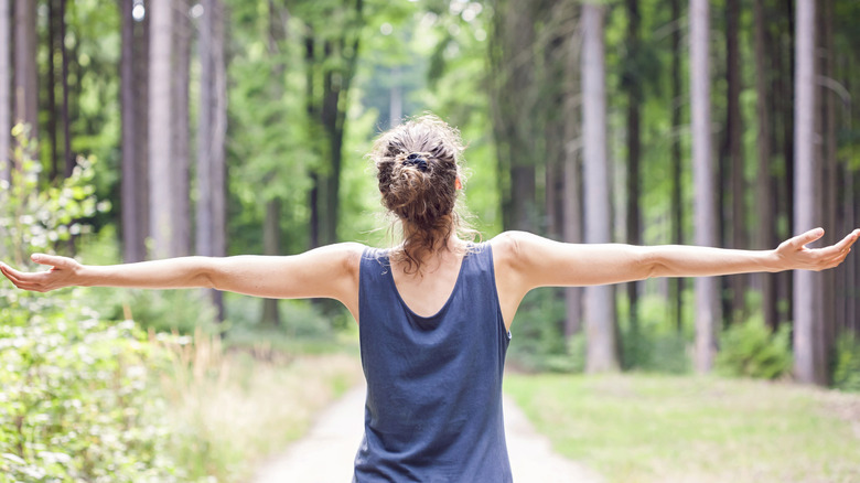 woman outdoors with outstretched arms