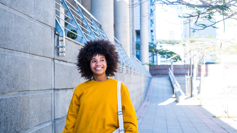 woman smiles while walking