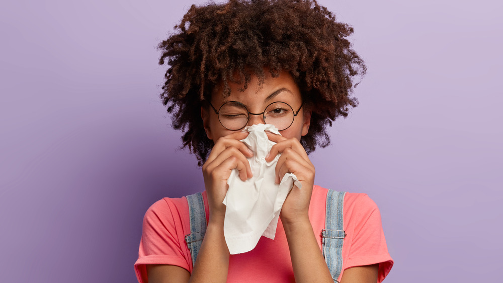 Woman sneezing 