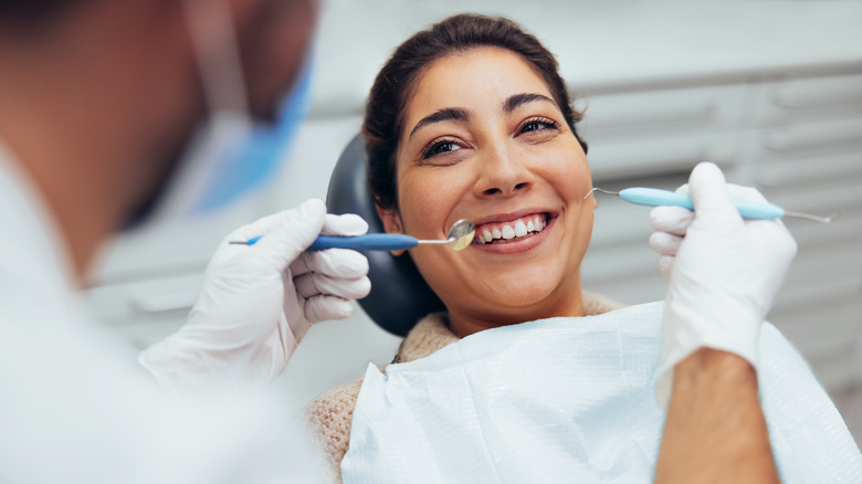 A woman gets her teeth cleaned at the dentist