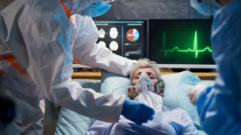 COVID-19 patient on ventilator in hospital bed