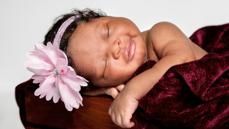 sleeping baby wearing flower headband