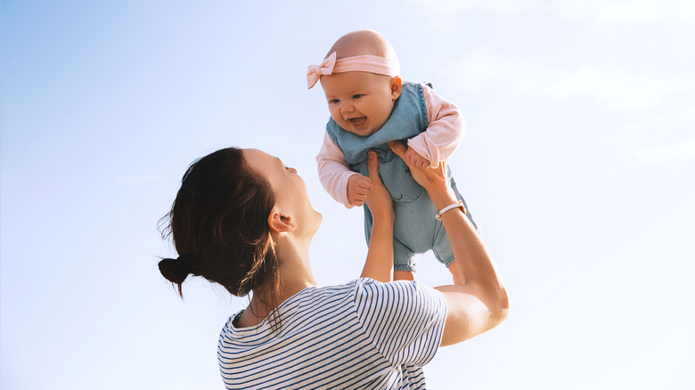 Happy baby and mother outside