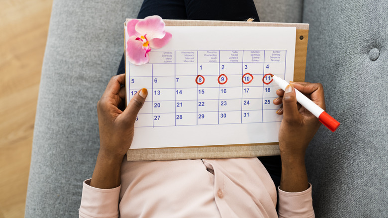 woman tracking period on calendar