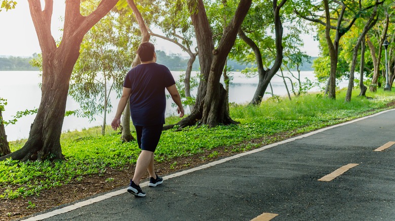 man walking down road