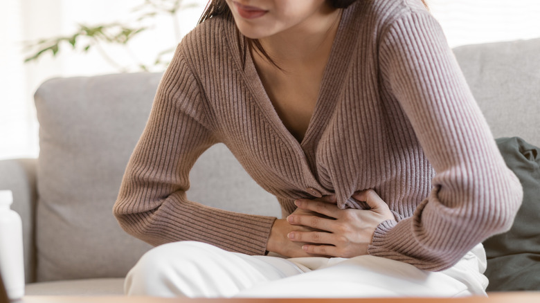 woman holding stomach