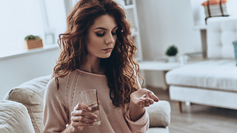 woman taking antibiotics